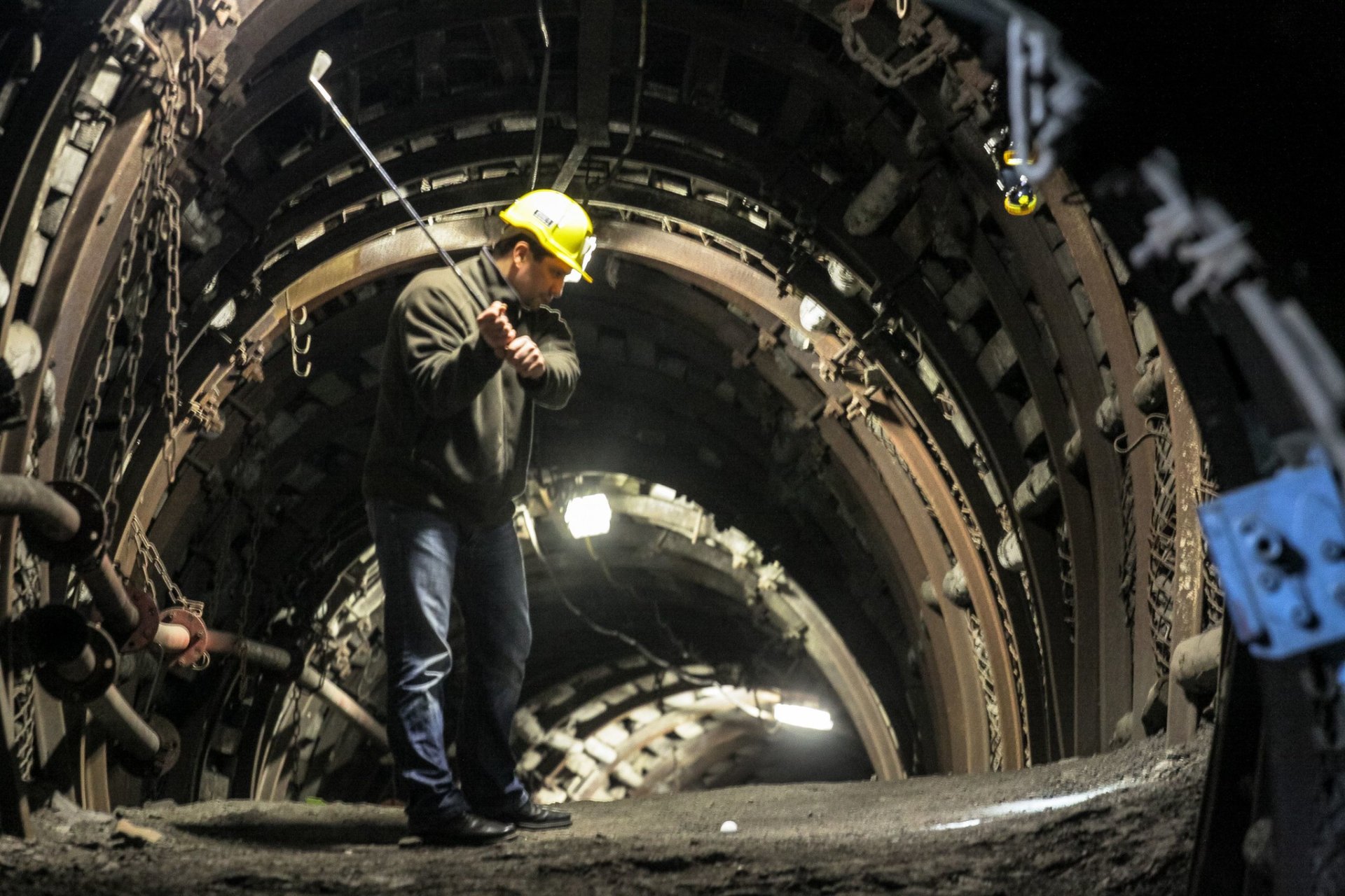 A miner plays golf inside the historic coal mine 