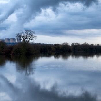 A lake with a power station in the distance.