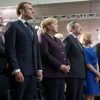 French President Emmanuel Macron, German chancellor Angela Merkel, and then ECB president Mario Draghi" Image via Flickr:europeancentralbank, used under CC BY / edited from original