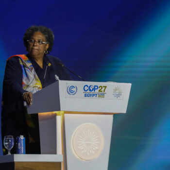 The image shows President Mottley speaking at COP27.