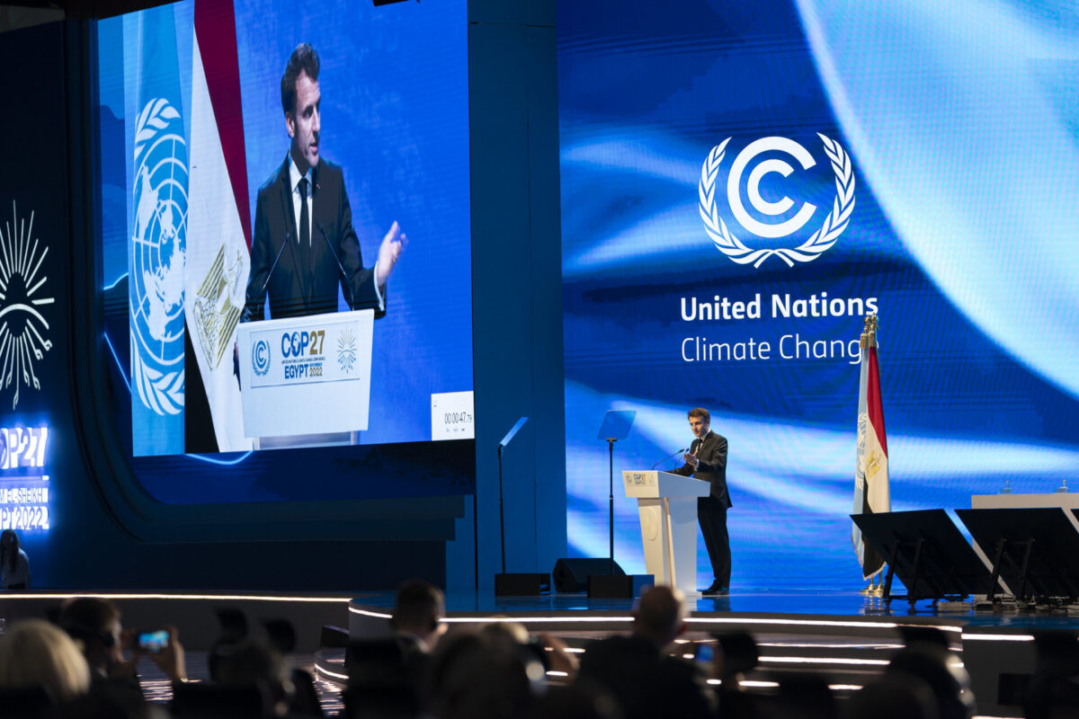 The photo was taken at the 27th Conference of Parties of the UNFCCC in Sharm El Sheikh, Egypt. In this photo, French President Emmanuel Macron announced that France will host an international Summit for a New Global Financing Pact in June 2023.