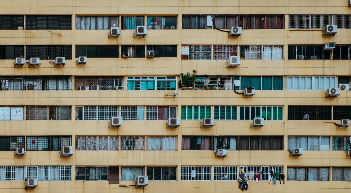 Block of flats showing windows and air conditioning units in Singapore