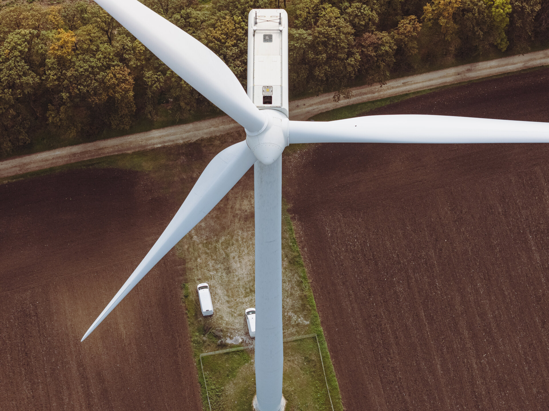 Wind turbine with open hatch. A worker prepares to go out for maintenance. The EU Green Deal and Zero Carbon Footprint