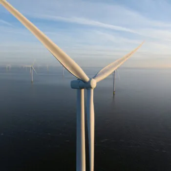 Wind turbines at the Afsluitdijk on water, converts the kinetic energy of wind into sustainable electrical energy, wind farms, renewable energy in The Netherlands.