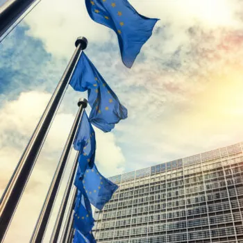 Waving EU flags in front of European Commission in Brussels