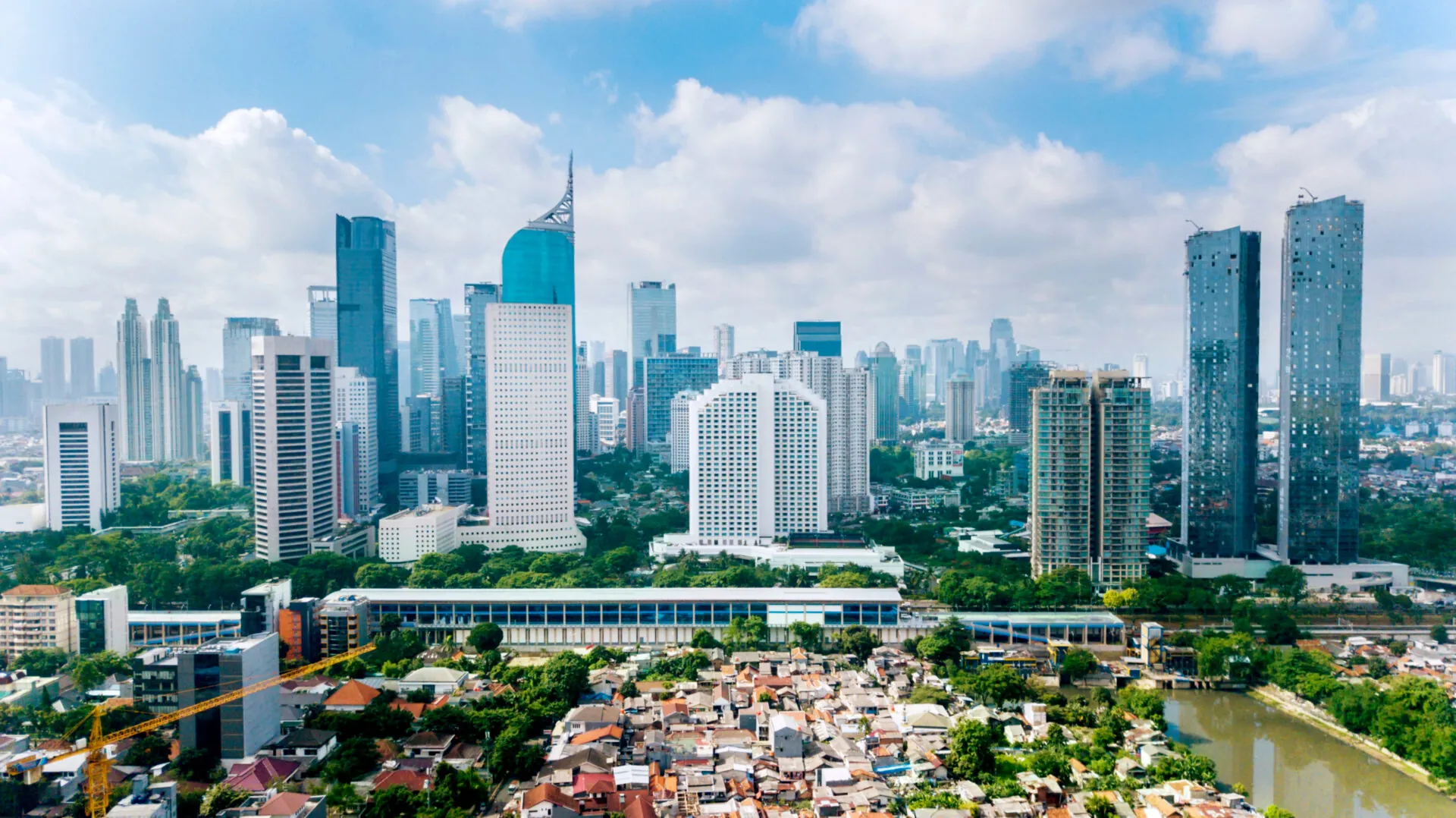 Panoramic view of Jakarta cityscape with residential houses, modern office and apartment buildings