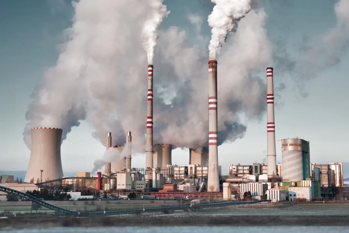 A coal-fired power station in the distance in agricultural lands