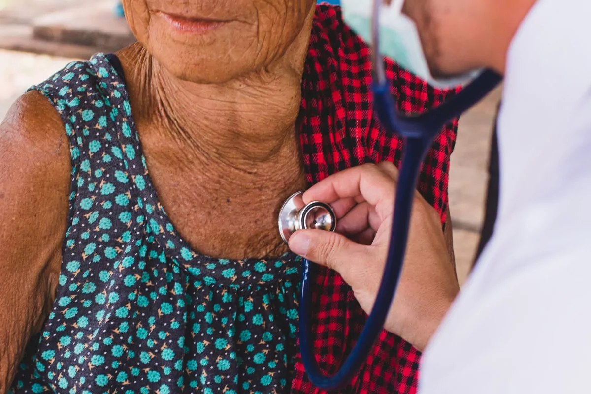 Doctor listening heart beat and breathing of Elderly Woman