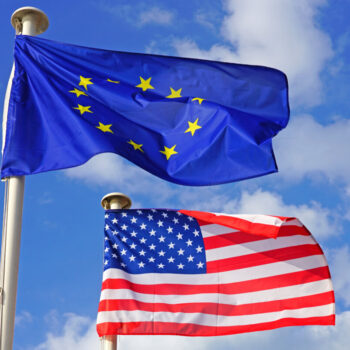 View of a flag of the European Union (EU) and of the United States flying side by side