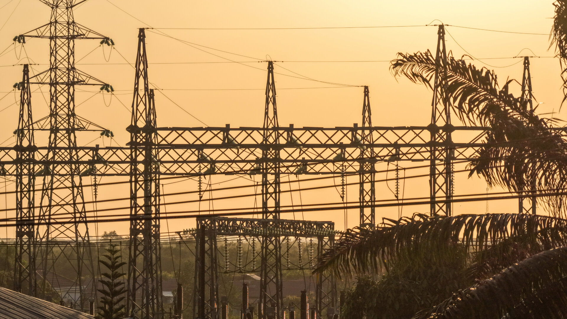 Silhouette of electrical power lines during a golden sunset in South Kalimantan, Indonesia