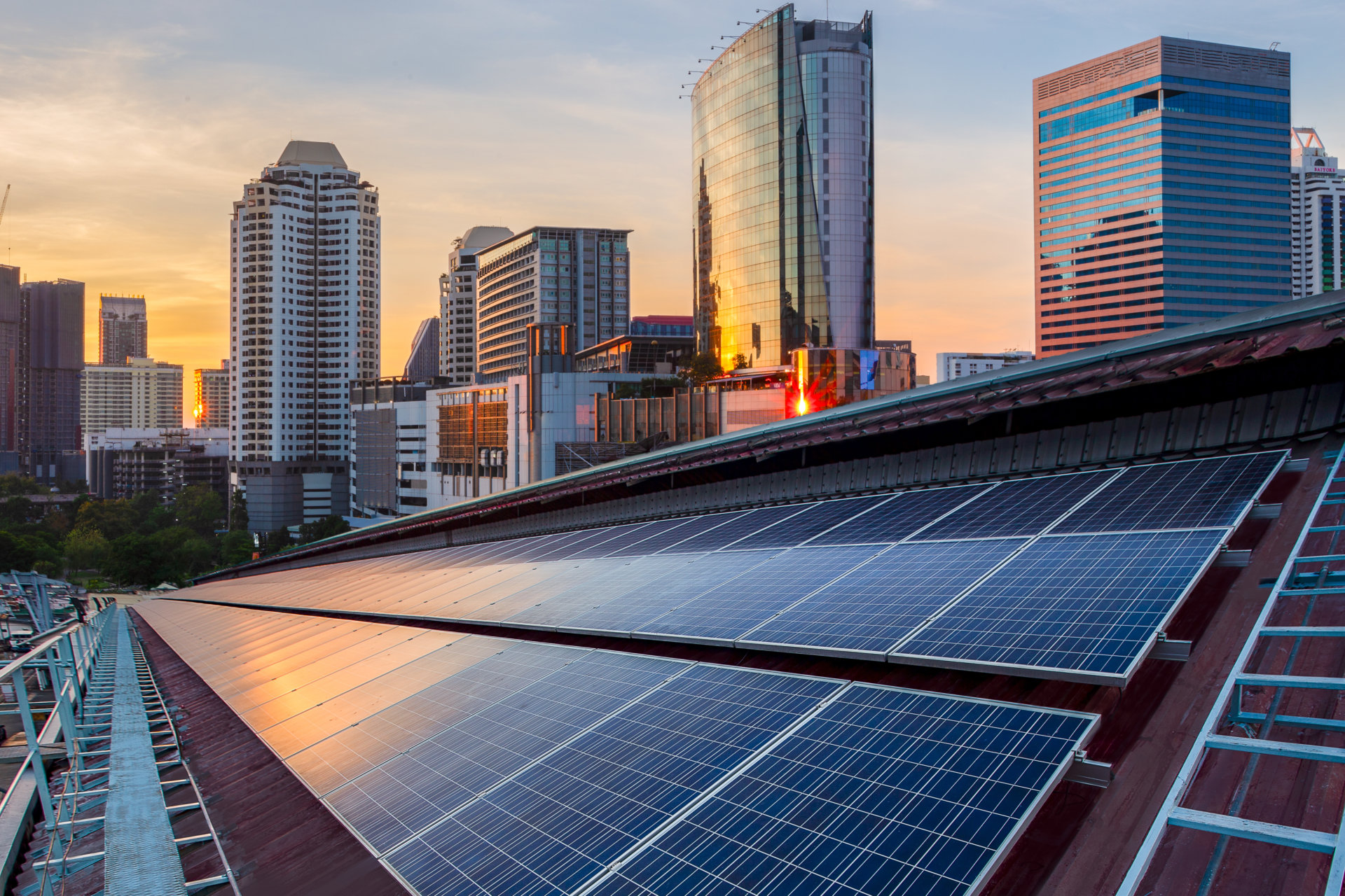 Solar Panel Photovoltaic installation on a Roof of factory, sunny blue sky background, alternative electricity source – Sustainable Resources Concept.