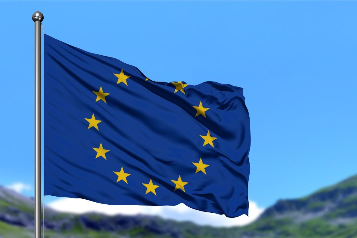 EU flag in front of green mountains