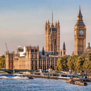 Big Ben and Houses of Parliament with boats on the river in London, England, UK