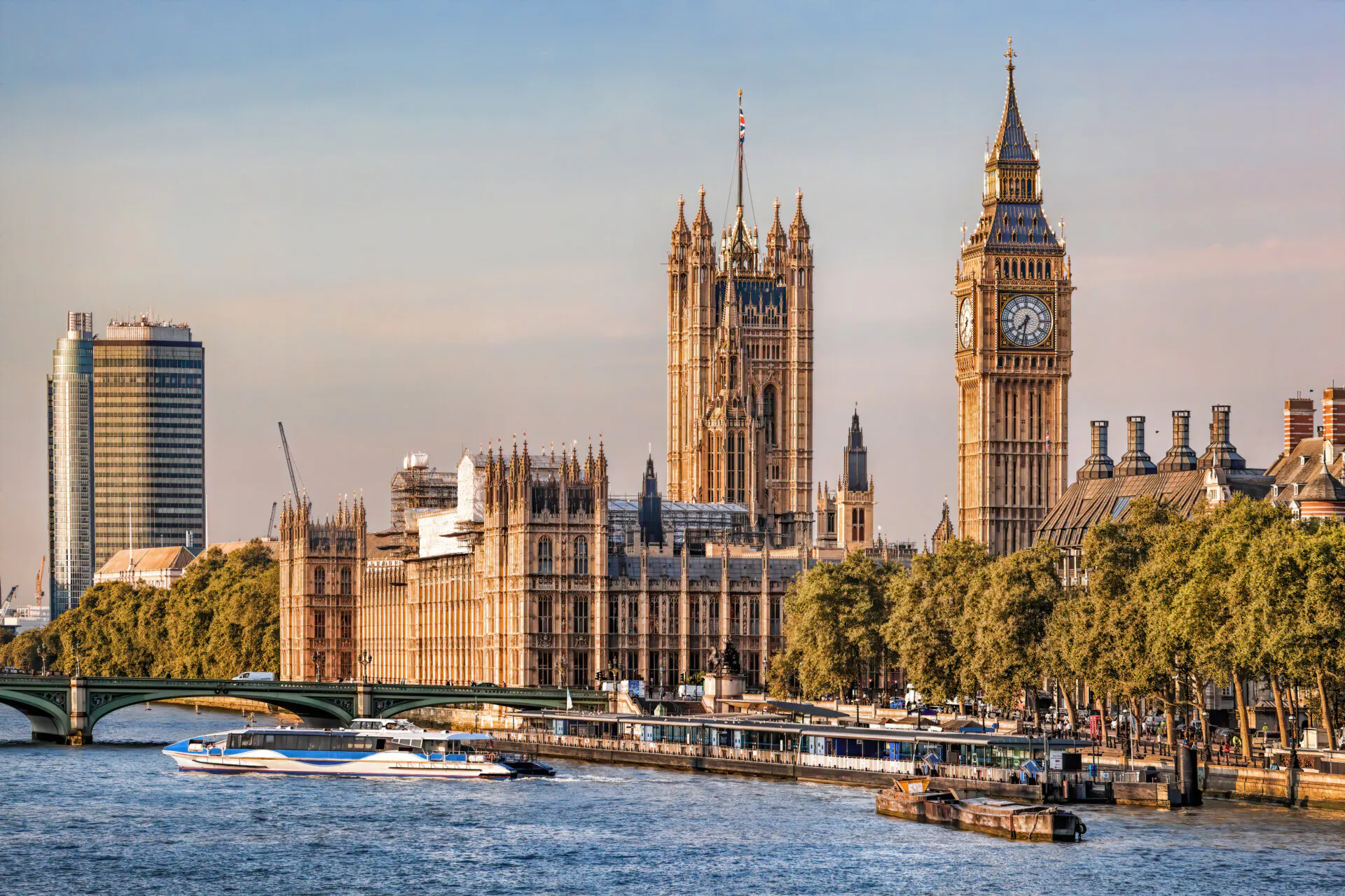 Big Ben and Houses of Parliament with boats on the river in London, England, UK