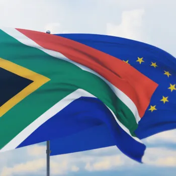 Waving European Union flag and flag of South Africa.