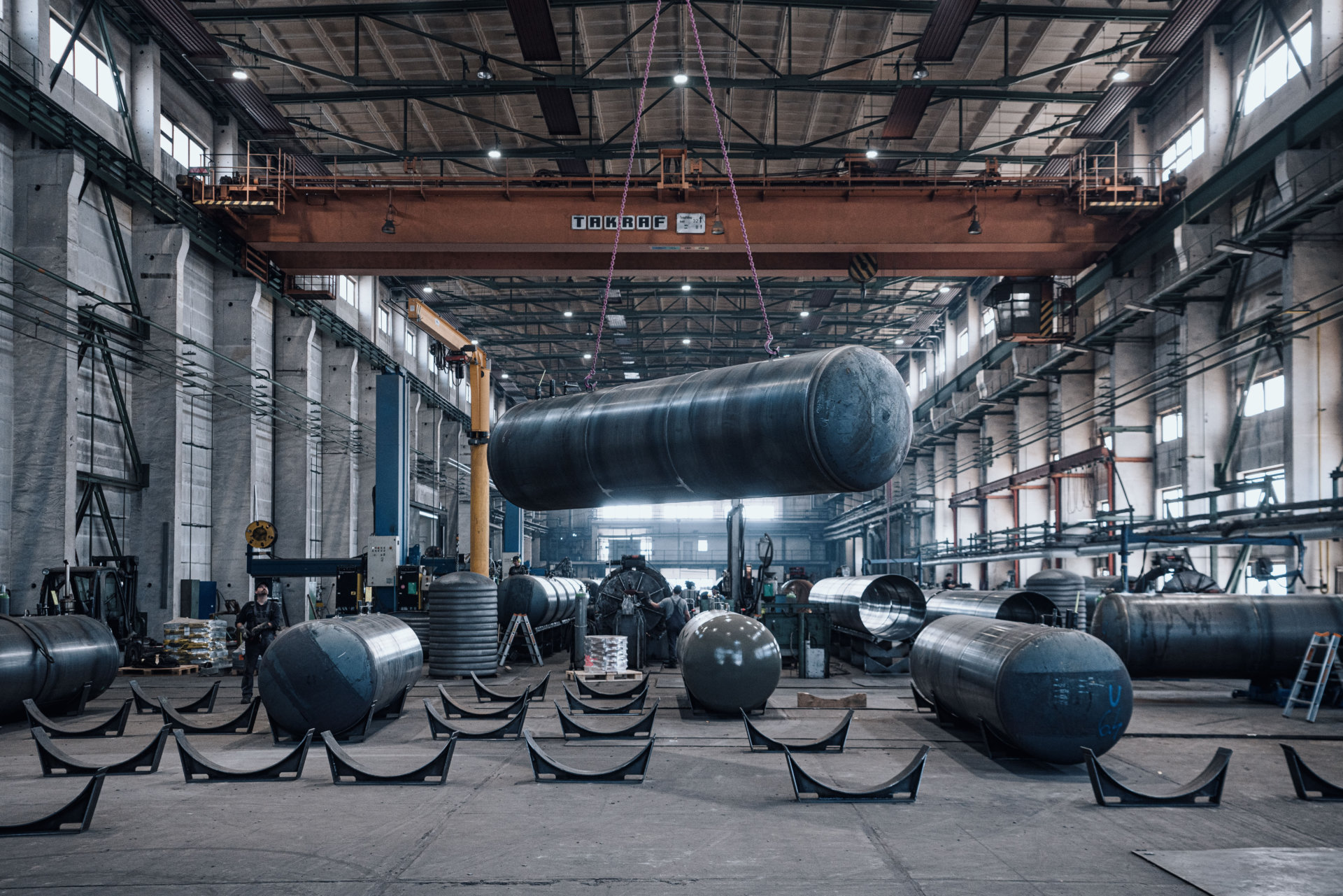 Heavy industry construction plant - Crane lifting heavy tanks during construction.