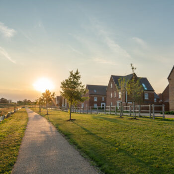 Empty walkway path at sunset near new build housing area in sout