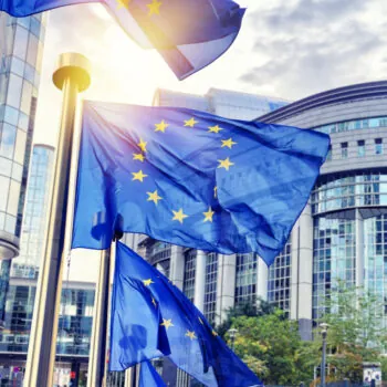 EU flags waving in front of European Parliament building in Brus