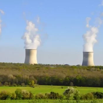 A green field with four factory chimneys behind, smoke coming out of each one. Cattenom nuclear plant, close to the Luxembourg border, a nuclear plant that would fall under the EU Taxonomy Delegated Act