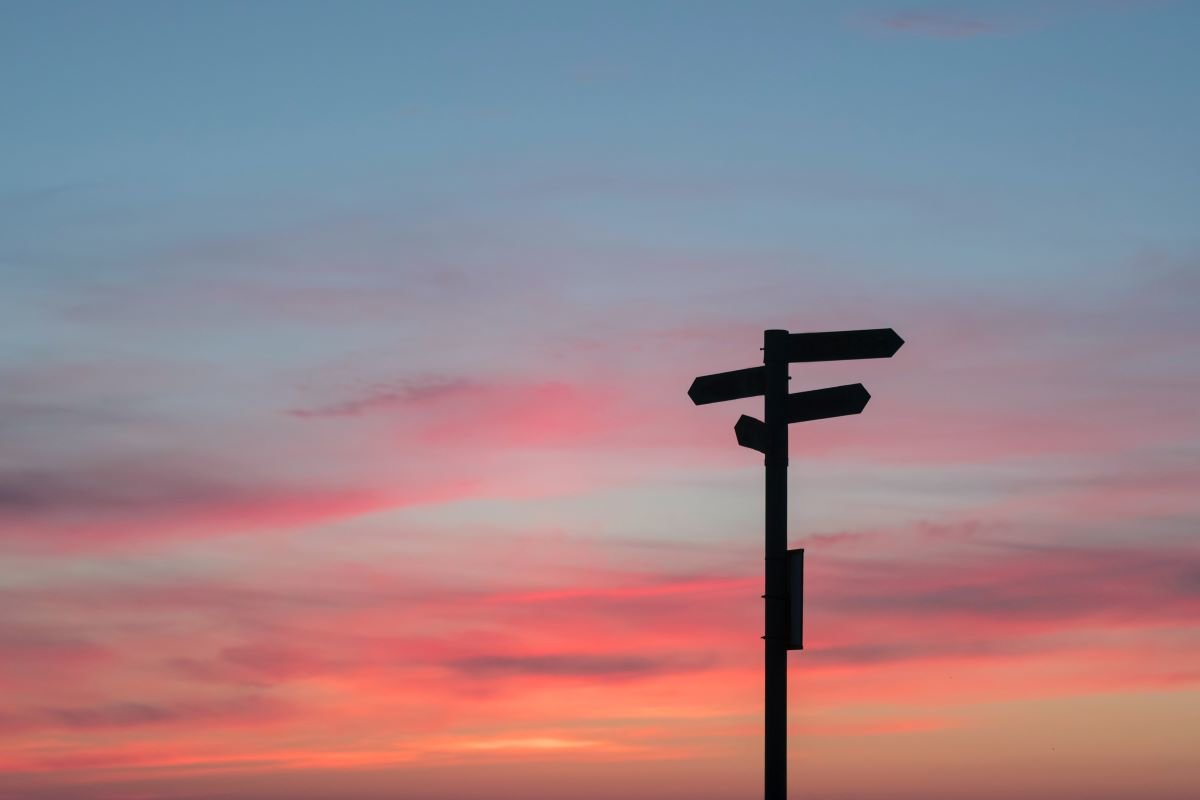 Crossroads at sunset and a signpost in A Coruña, Spain - unsplash