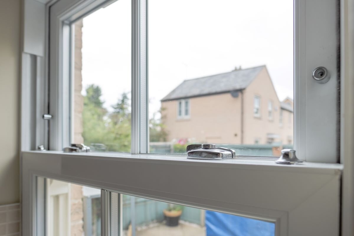 Detailed view of a newly installed, energy saving double glazed sash window. Energy efficiency measures like these are a key way to get the UK off Russian gas. Photo via Adobe