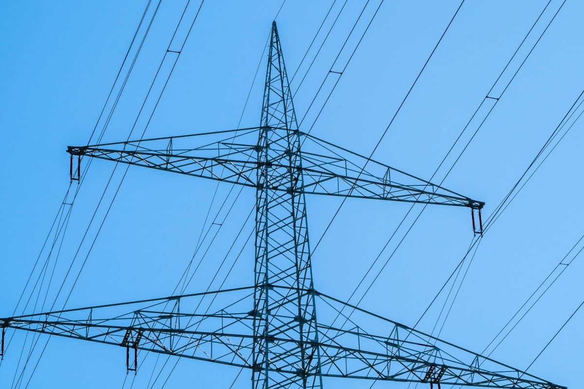 Electricity grid against a blue sky.