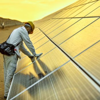 Engineer installing solar photovoltaic power station in the desert