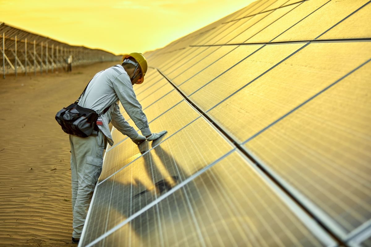 Engineer installing solar photovoltaic power station in the desert