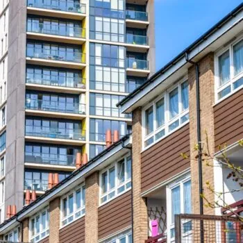 English terraced houses in front of modern tower block flats in London. Around two-thirds of privately rented properties in England and Wales fall below EPC C but at present there are no universally available incentives for landlords to increase the energy performance of the property.