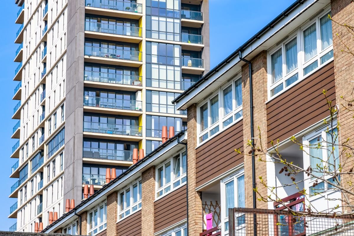 English terraced houses in front of modern tower block flats in London. Around two-thirds of privately rented properties in England and Wales fall below EPC C but at present there are no universally available incentives for landlords to increase the energy performance of the property.