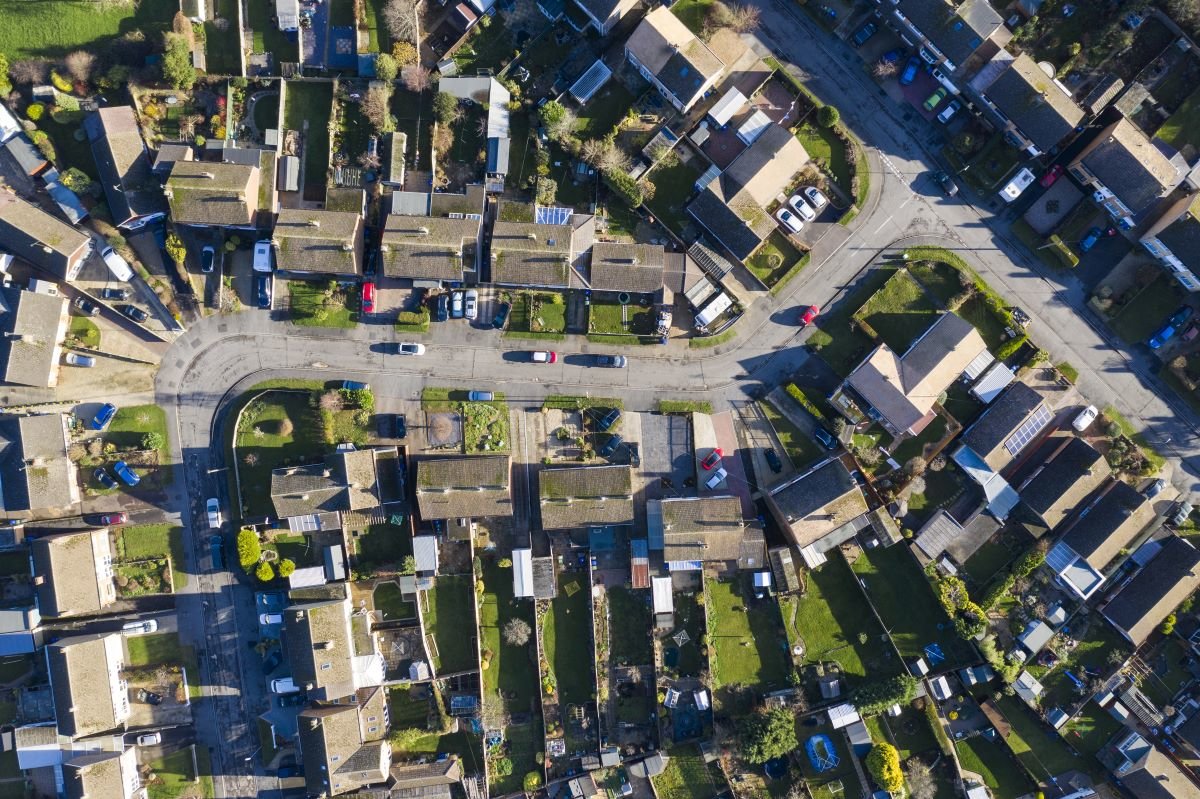 Aerial view of homes in suburban England. Decarbonising home heating is key for UK homes.