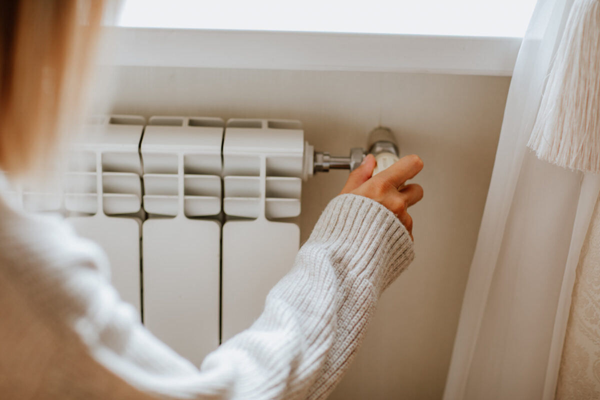 A woman adjusting a home radiator