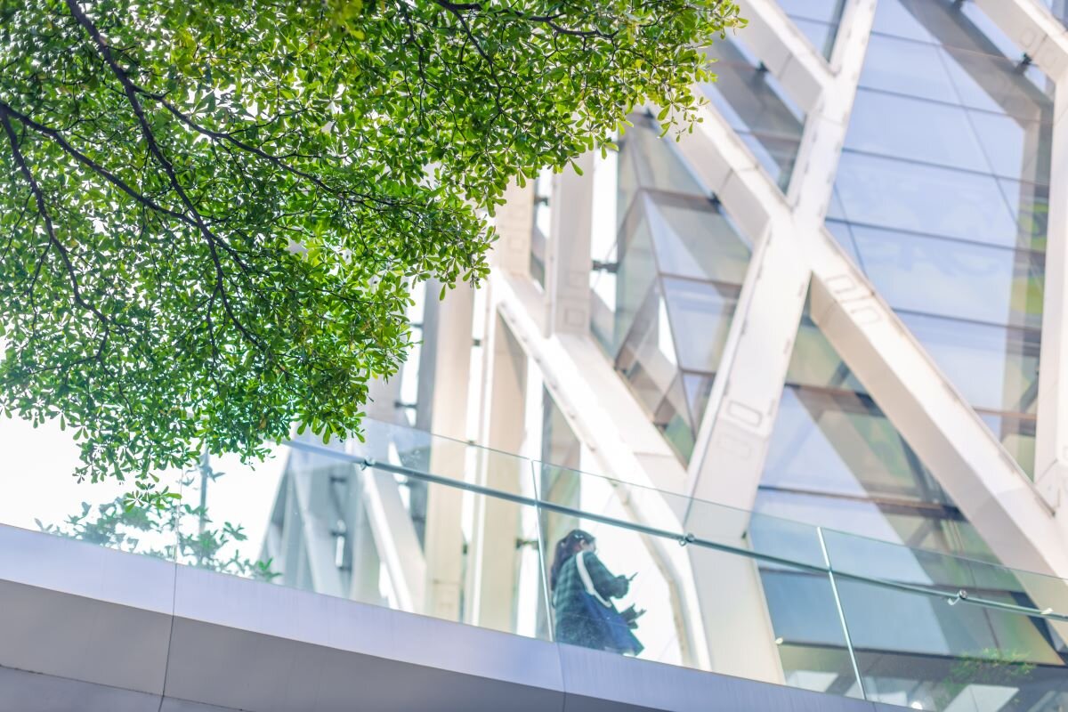 Modern office building surrounded by green. The ISSB standards will serve as the global baseline for sustainability disclosures on sustainability and climate, supporting the global climate transition.
