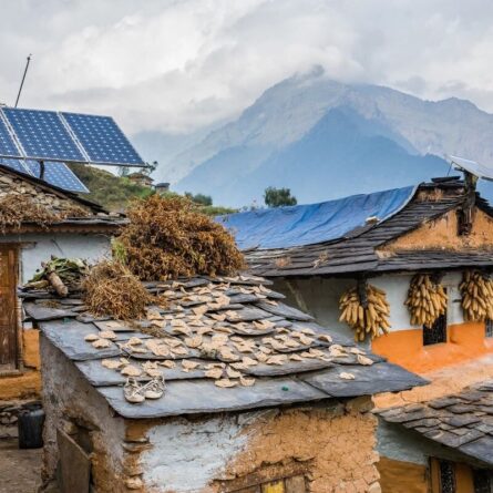 Nepali traditional houses with solar cell panel on the roof. Muri village, Dhaulagiri region. distributed renewables and small-scale storage, are well suited to expand energy access and deliver a quick, affordable, and equitable energy transition.