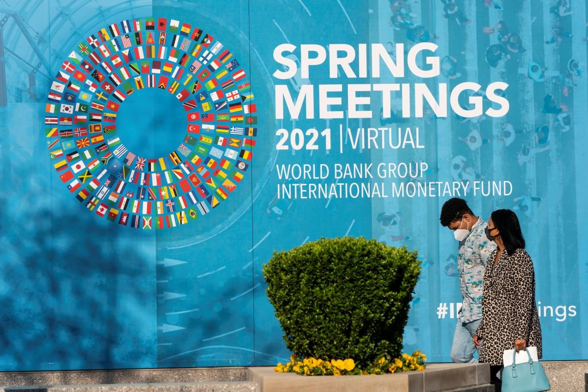 People walk past the IMF HQ2 during the 2021 Spring Meetings at the International Monetary Fund. IMF Joshua Roberts via Flickr