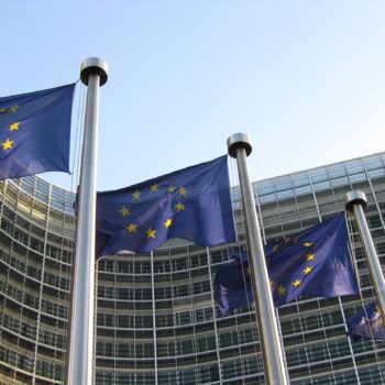 EU flags next to Berlaymont building, the European Commissions's headquarters in Brussels, Belgium.