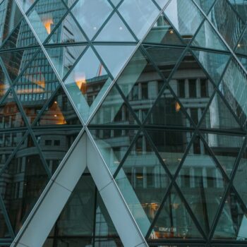 Reflection of the finance district of London in the Gherkin. Photo by Constantin Hyp on Unsplash.