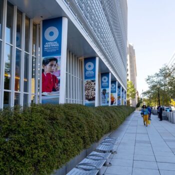 Road outside the main headquarters of the World Bank Group with Annual Meetings signage. Photo by Simone McCourtie for World Bank Group on flickr.