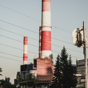 The image shows the red and white striped chimneys of a gas power plant in Penza, Russia. - EU's Russian gas phase-out