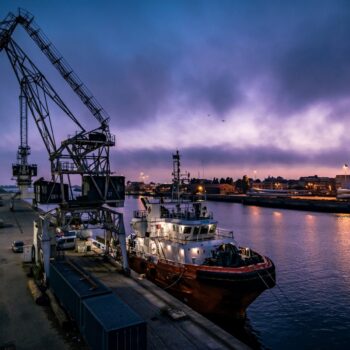 The image shows a cargo ship in the sea trade port of Matosinhos, Porto in Portugal