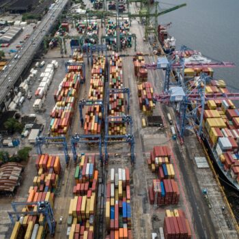 Seaport of Rio de Janeiro, Brazil, full of ships and containers for importing and exporting products. Photo via Adobe Stock.