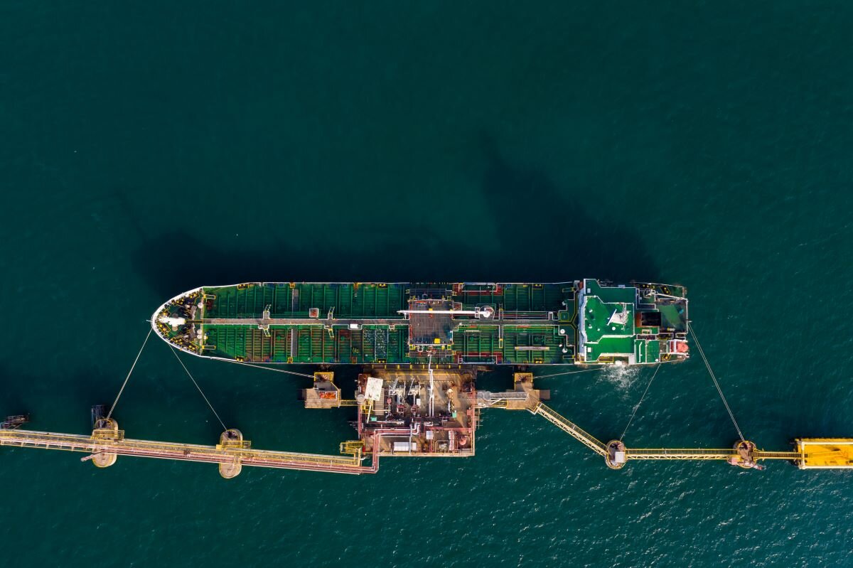Shipping oil tank on the green sea. Photo via Adobe.