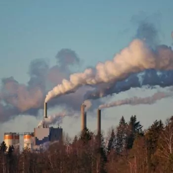 Smoke rising towards the sky from the chimneys of a paper mill in Sweden.