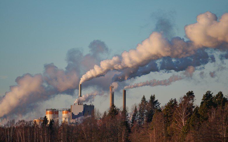 Smoke rising towards the sky from the chimneys of a paper mill in Sweden.