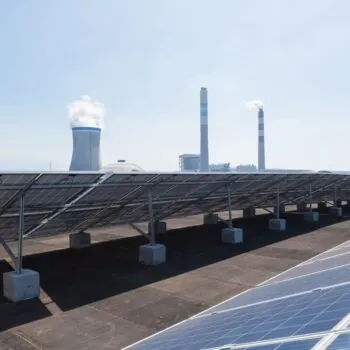 Solar panels in foreground crowd out coal power. All major world regions have seen the scale of new coal under consideration decline or plateau since mid-2022.