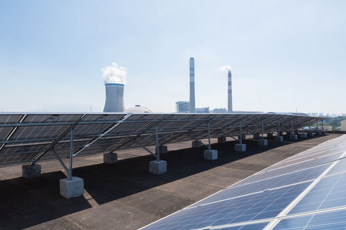 Solar panels in foreground crowd out coal power. All major world regions have seen the scale of new coal under consideration decline or plateau since mid-2022.