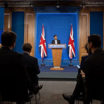 The Prime Minister stands at a podium between two UK flags, holds a 'Net Zero' press conference on Sept 20th 2023.