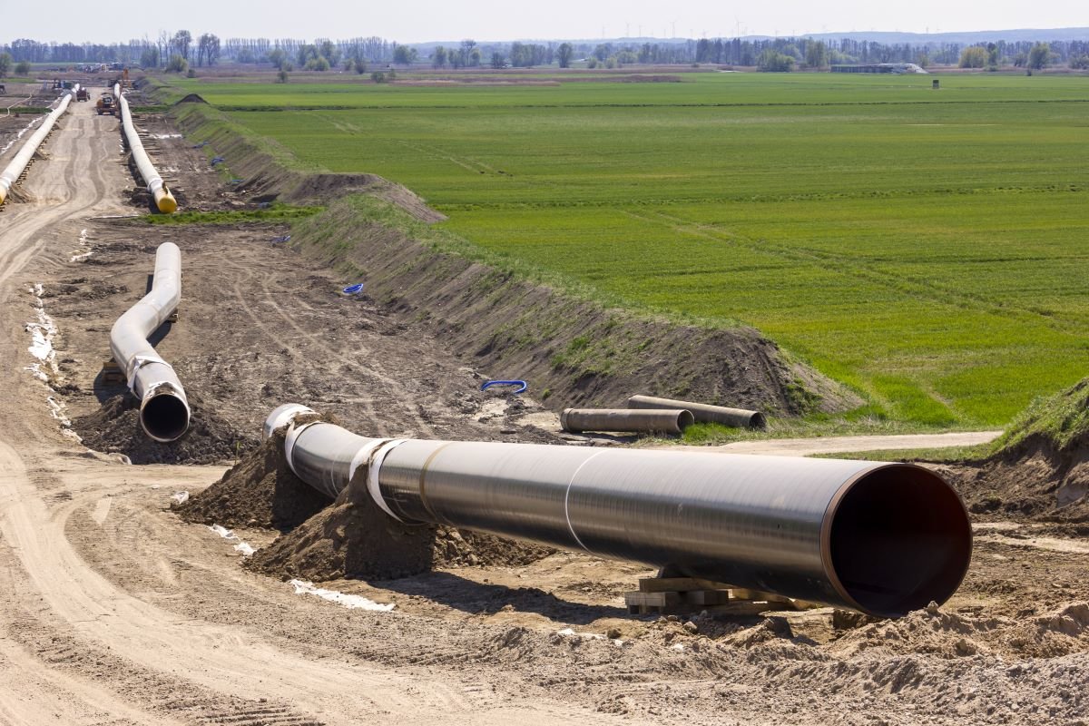 Unassembled gas pipeline lies on a field in Germany, ready to be installed