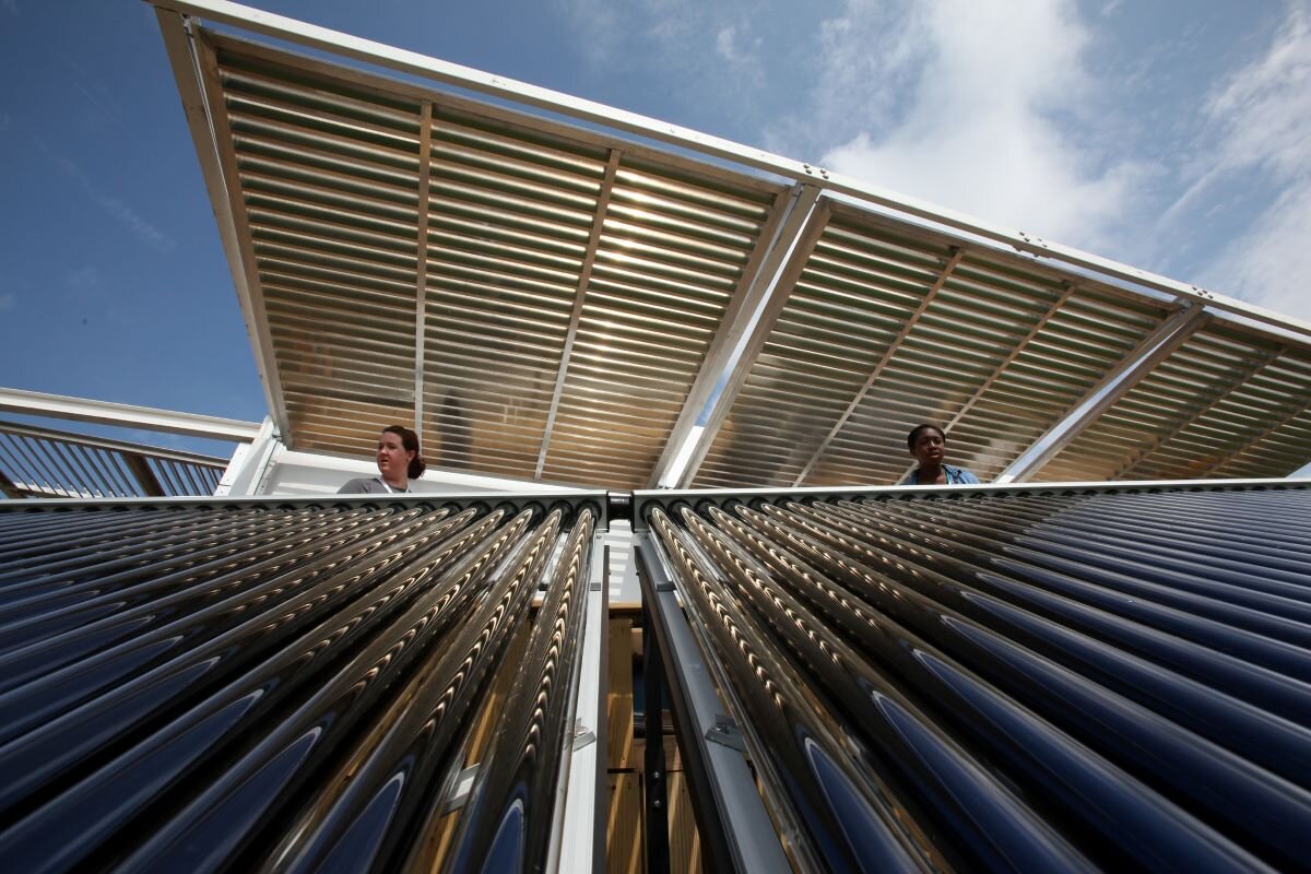 Two engineers look out over FIU Solar Thermal Collector System. Photo by Stefano Paltera via U.S. Department of Energy Solar Decathlon on flickr.