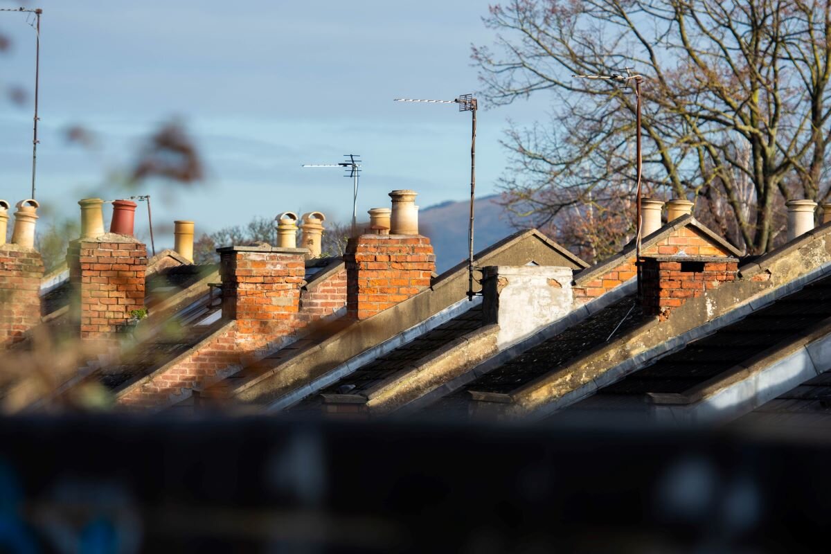 a line of roofs on a street of houses in the uk